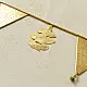 handmade brass triangle design toran door hanging featuring pennant shaped brass flags linked on a brass chain with central floral pendant drop   