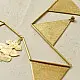 handmade brass triangle design toran door hanging featuring pennant shaped brass flags linked on a brass chain with central floral pendant drop   