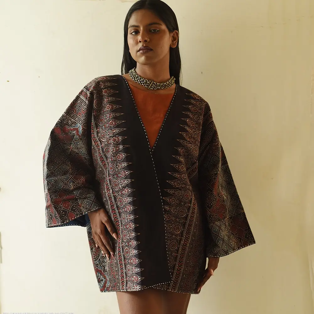 reversible ajrakh hand block printed kimono jacket black base madder red interlocking floral jaal block print solid black reverse sustainable luxury outerwear artisanal jacket