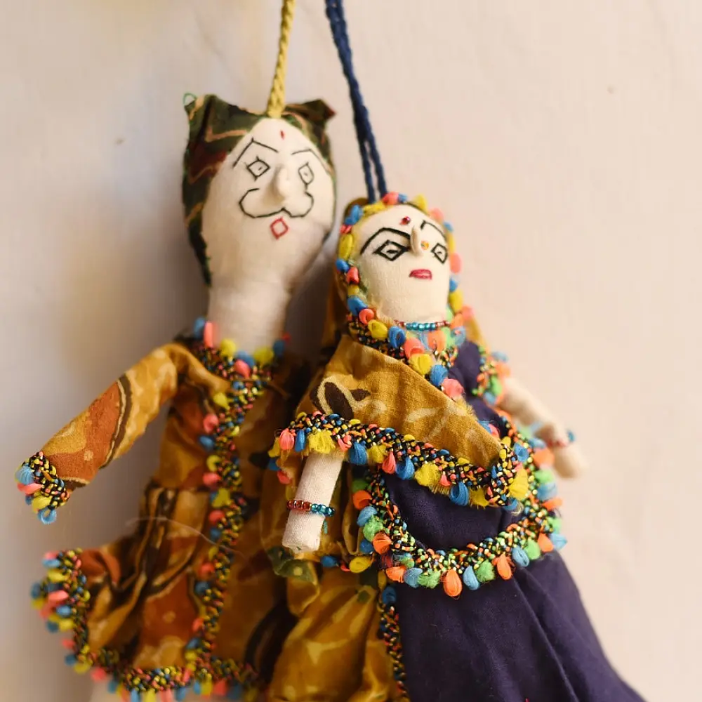 handcrafted traditional kutchi cloth dolls in deep blue and gold ethnic outfits with mirror work embroidery