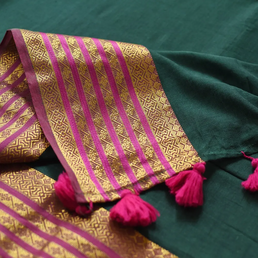 handloom pure cotton saree in deep forest green with contrasting magenta pink striped zari border and handcrafted tassels on pallu