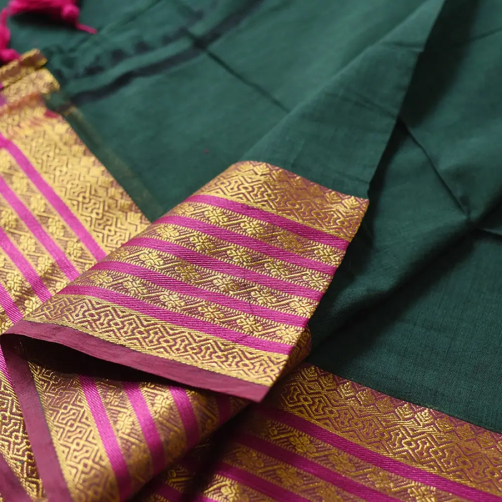 handloom pure cotton saree in deep forest green with contrasting magenta pink striped zari border and handcrafted tassels on pallu