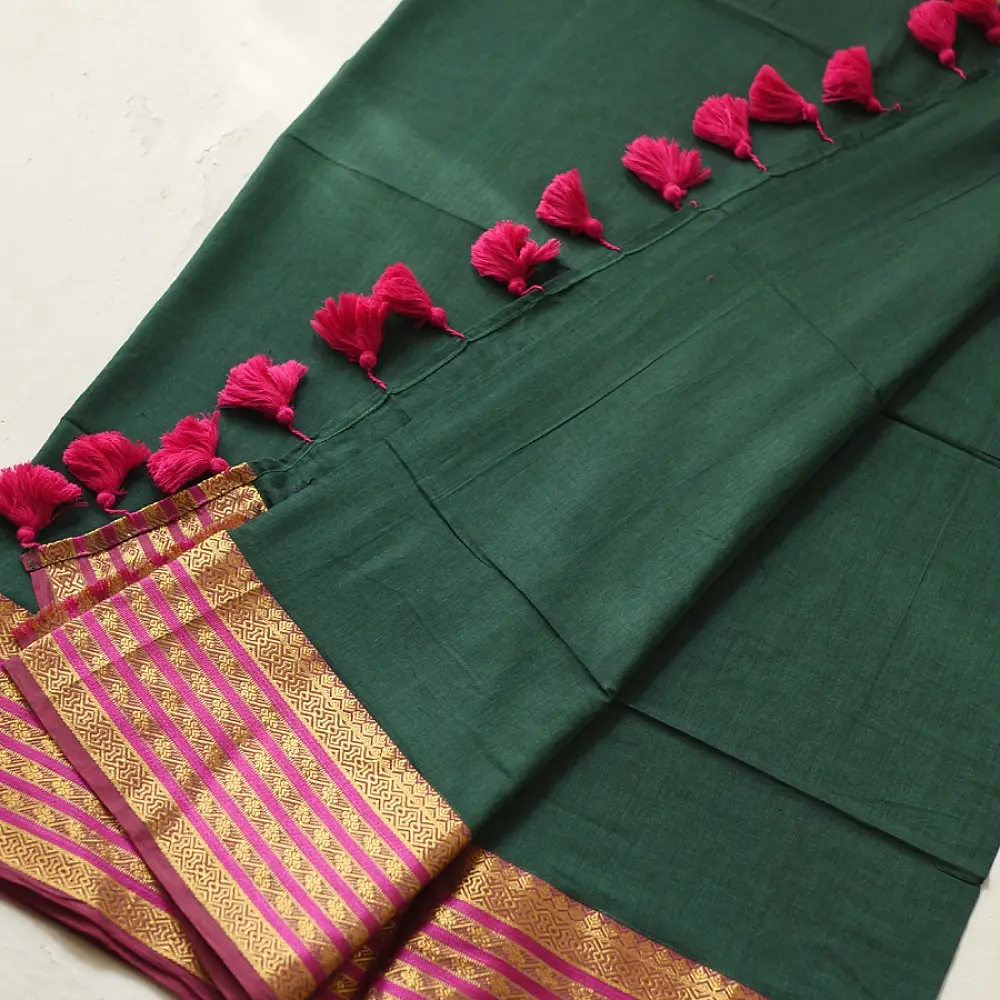 handloom pure cotton saree in deep forest green with contrasting magenta pink striped zari border and handcrafted tassels on pallu