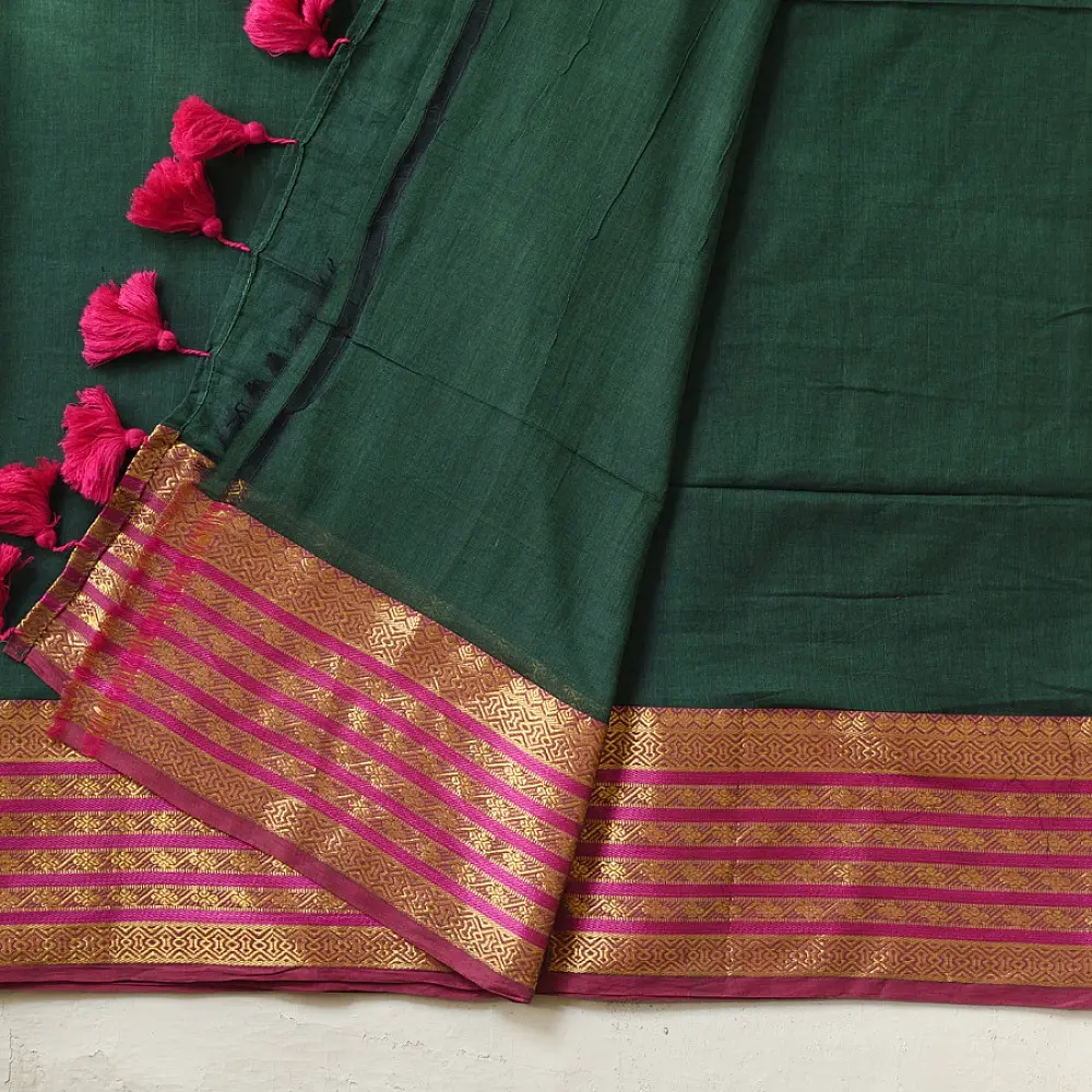 handloom pure cotton saree in deep forest green with contrasting magenta pink striped zari border and handcrafted tassels on pallu