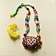 handcrafted banjara triangular embroidered fabric pendant necklace with mirror work pom poms and bright green dori cord
