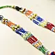 handcrafted banjara triangular embroidered fabric pendant necklace with mirror work pom poms and bright green dori cord