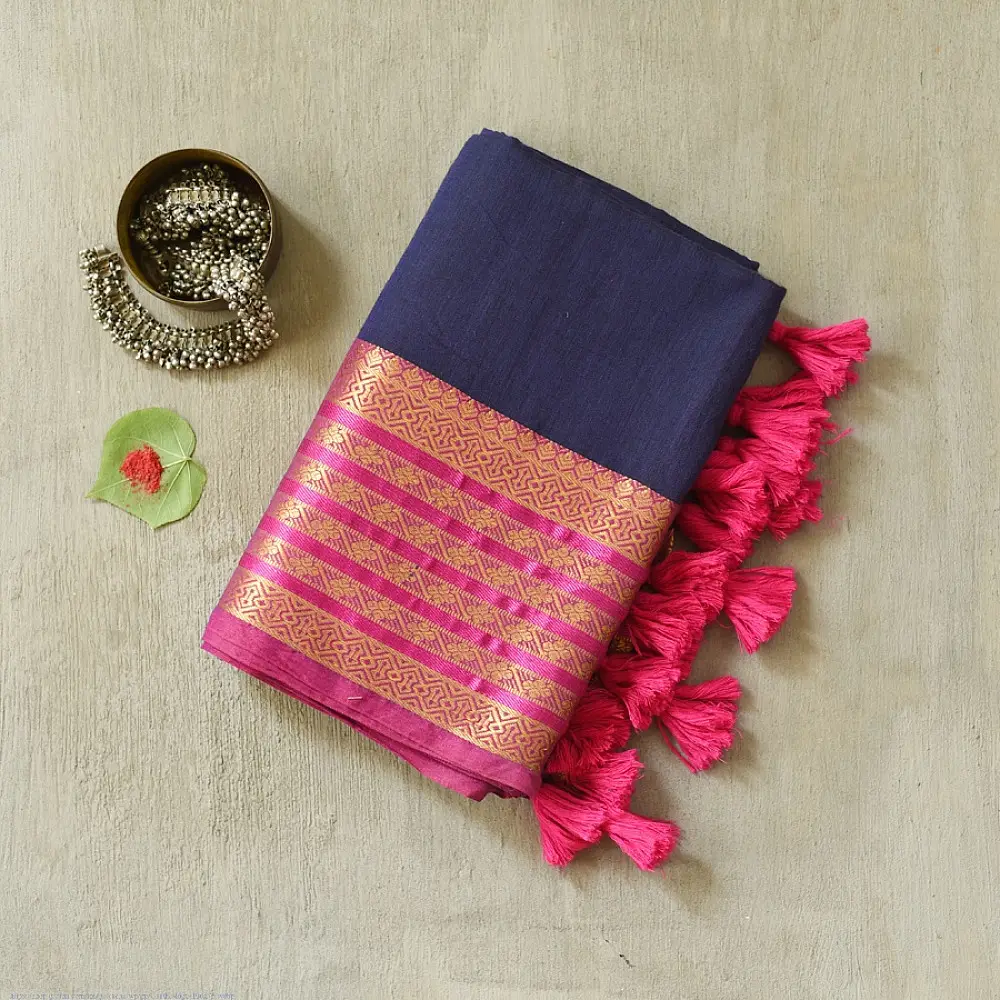 handloom pure cotton saree in deep ink blue with contrasting magenta pink striped zari border and handcrafted tassels on pallu 