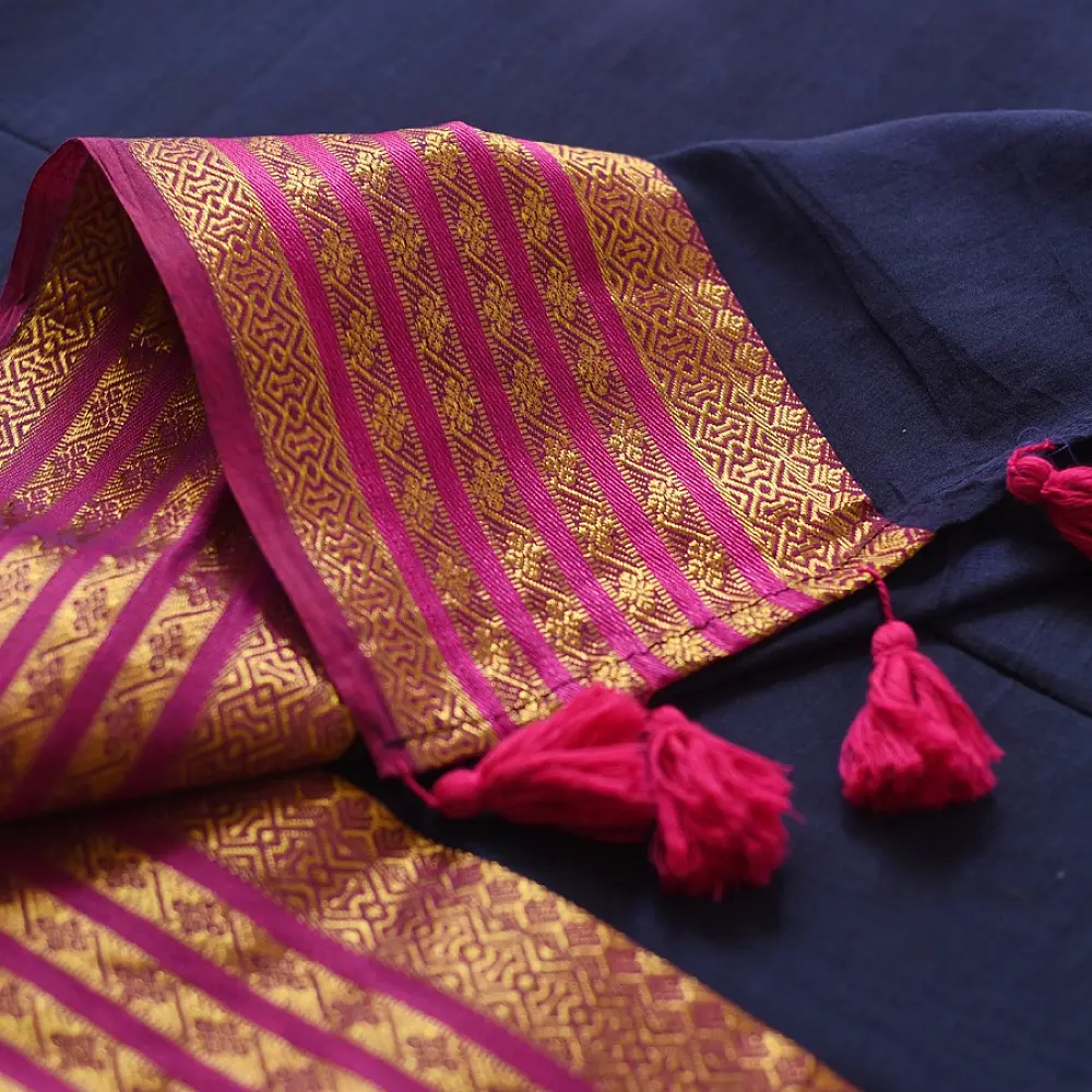 handloom pure cotton saree in deep ink blue with contrasting magenta pink striped zari border and handcrafted tassels on pallu 