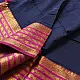 handloom pure cotton saree in deep ink blue with contrasting magenta pink striped zari border and handcrafted tassels on pallu 