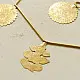 handmade brass toran door hanging featuring scalloped circular brass discs linked on a brass chain with a central floral pendant drop   