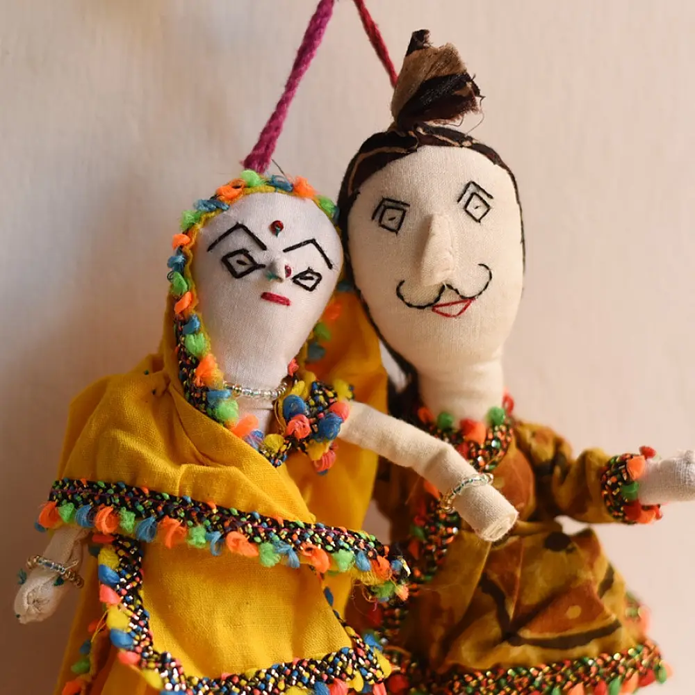 handcrafted traditional kutchi couple cloth dolls in yellow and white ethnic outfits with mirror work embroidery
