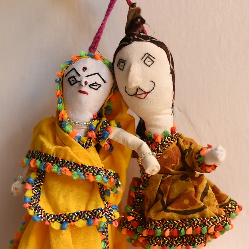 handcrafted traditional kutchi couple cloth dolls in yellow and white ethnic outfits with mirror work embroidery