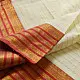handloom pure cotton saree in soft ivory white featuring a contrasting rust orange striped zari border and handcrafted tassels on pallu