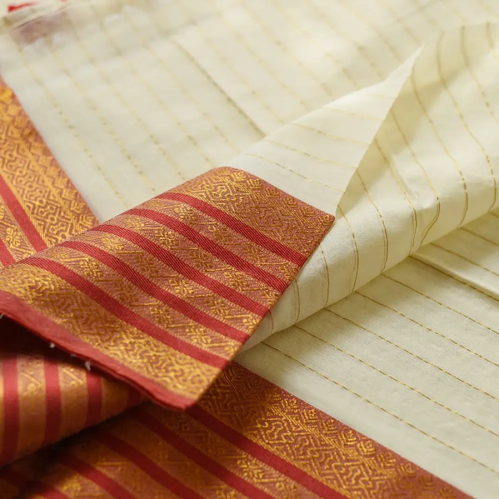 handloom pure cotton saree in soft ivory white featuring a contrasting rust orange striped zari border and handcrafted tassels on pallu