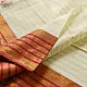 handloom pure cotton saree in soft ivory white featuring a contrasting rust orange striped zari border and handcrafted tassels on pallu