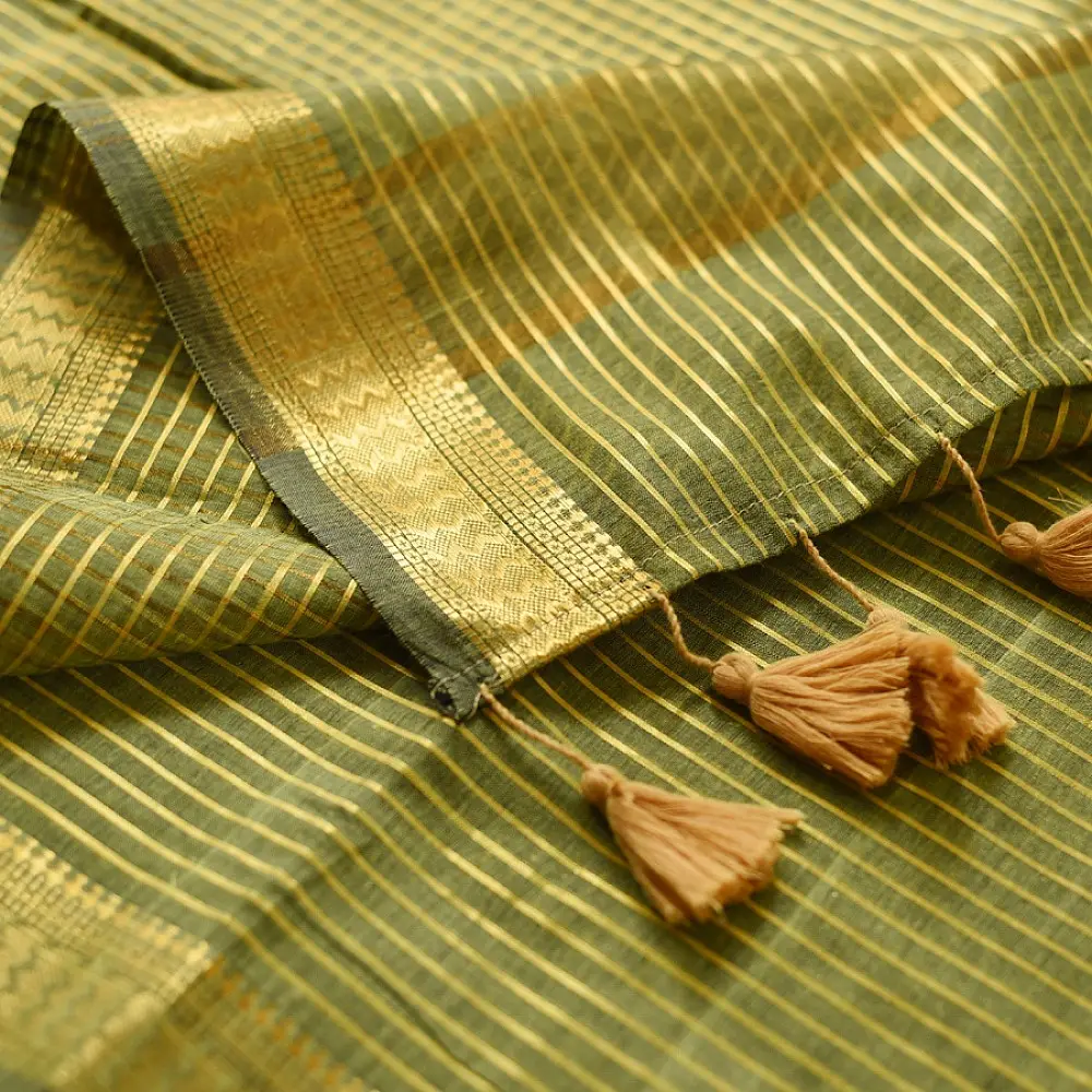 handloom pure cotton saree in subtle olive heena green with woven golden zari striped border and matching handcrafted tassels on pallu