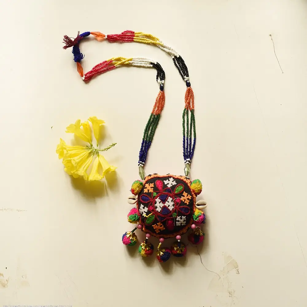 handcrafted banjara round embroidered fabric pendant necklace with mirror work pom poms cowrie shells and multi strand beaded chain