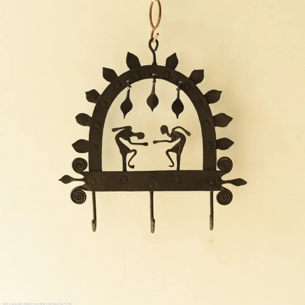 handcrafted black wrought iron arched wall hanger featuring two stylized tribal human figures, top hanging dome drops, and lower storage hooks