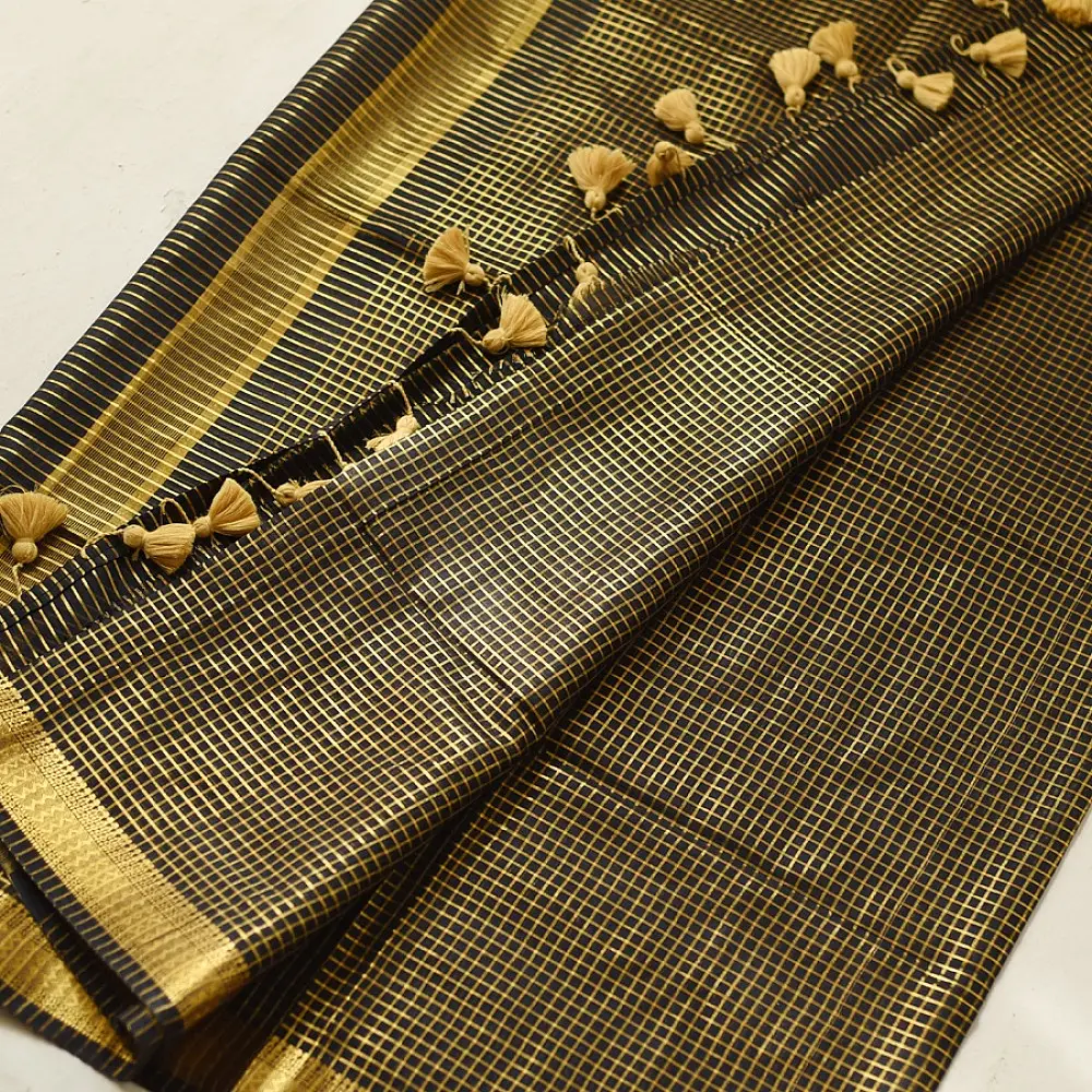handloom pure cotton saree in classic black featuring fine golden zari checked pattern throughout the body with a rich gold zari border and handcrafted tassels