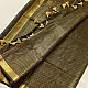 handloom pure cotton saree in classic black featuring fine golden zari checked pattern throughout the body with a rich gold zari border and handcrafted tassels