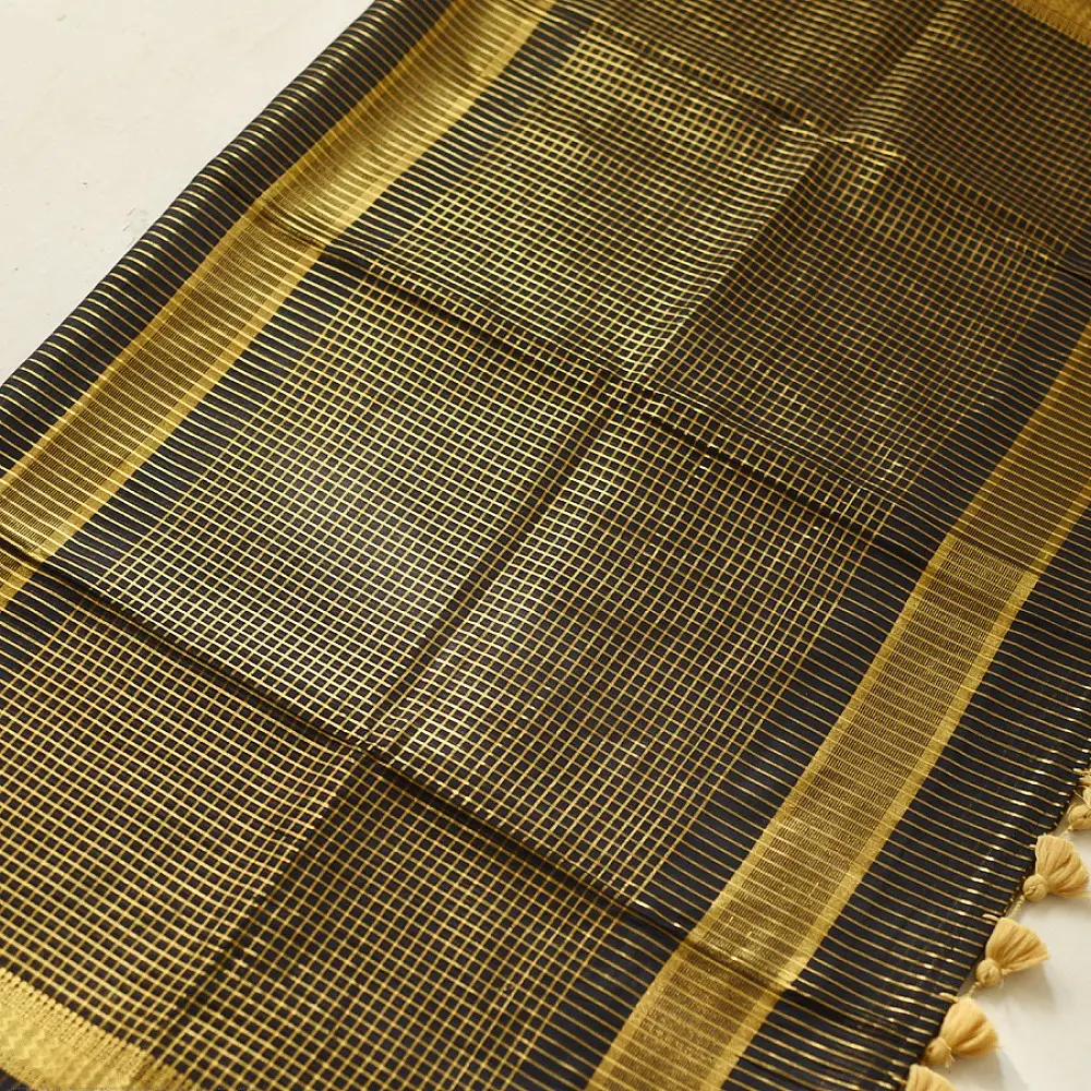 handloom pure cotton saree in classic black featuring fine golden zari checked pattern throughout the body with a rich gold zari border and handcrafted tassels