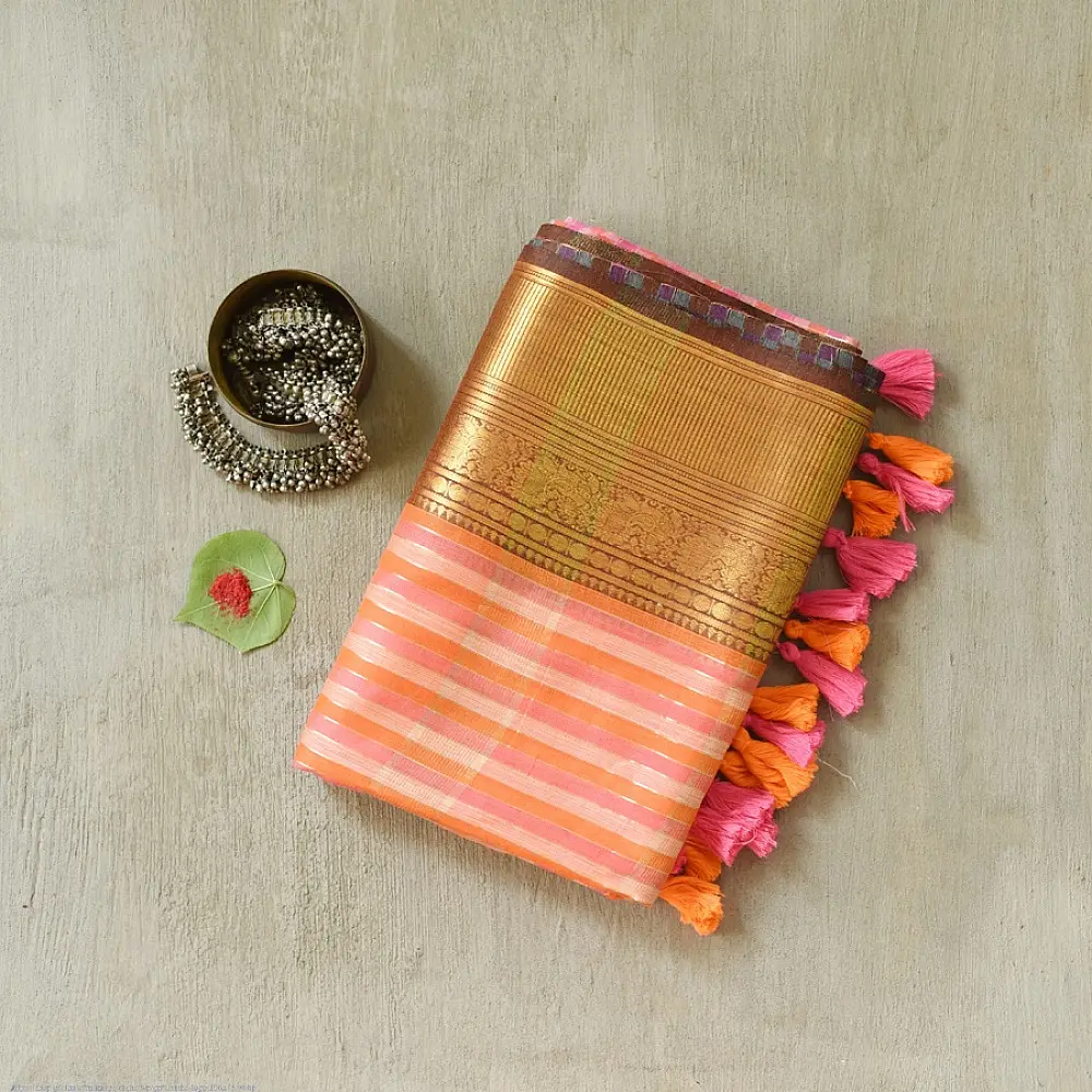 handloom pure cotton saree with peach and orange sunset striped pattern woven gold zari border and handcrafted pink and orange tassels