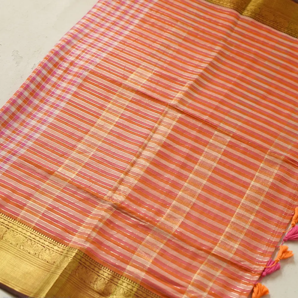 handloom pure cotton saree with peach and orange sunset striped pattern woven gold zari border and handcrafted pink and orange tassels