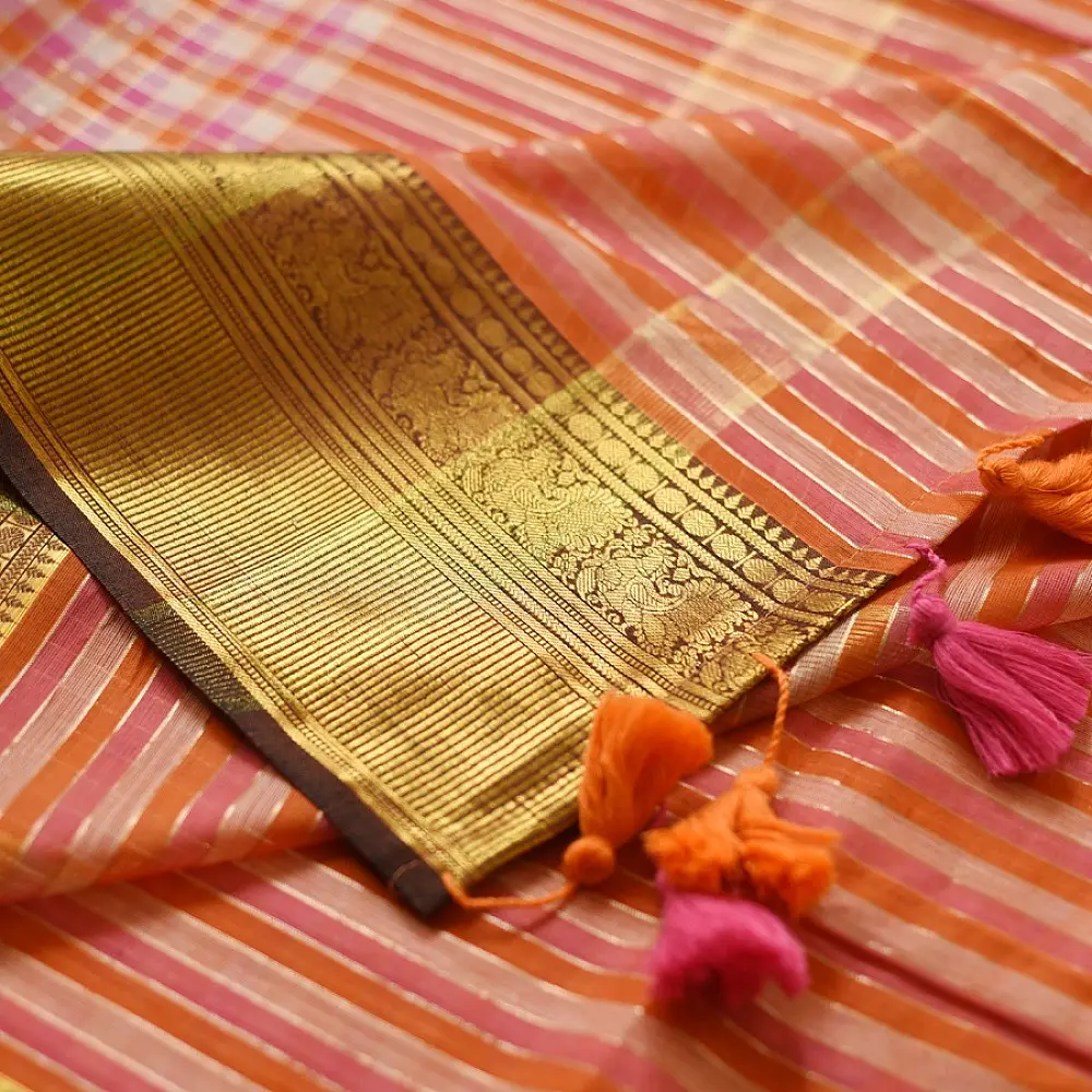 handloom pure cotton saree with peach and orange sunset striped pattern woven gold zari border and handcrafted pink and orange tassels