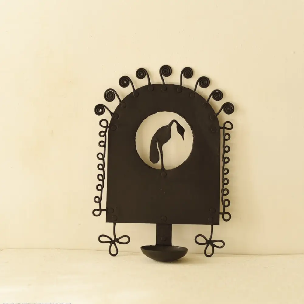 handcrafted black wrought iron wall hanging candle holder featuring a central circular cutout with a crane silhouette and an arched frame with spiral scrolls