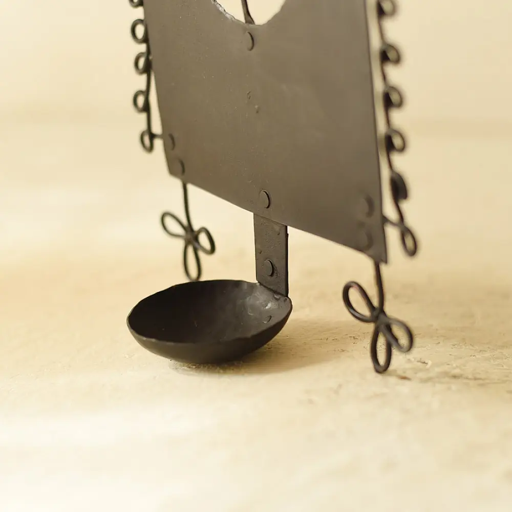 handcrafted black wrought iron wall hanging candle holder featuring a central circular cutout with a crane silhouette and an arched frame with spiral scrolls