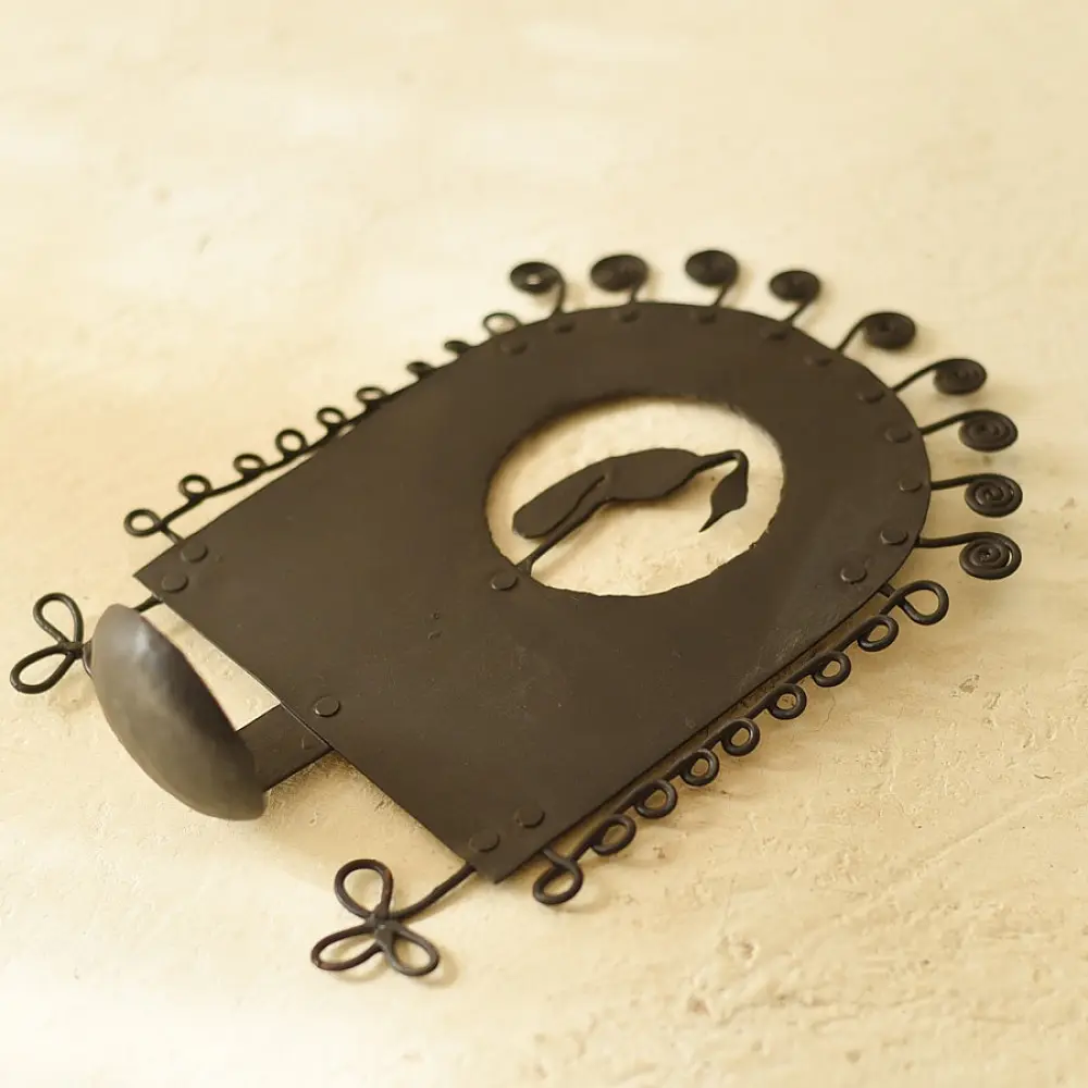 handcrafted black wrought iron wall hanging candle holder featuring a central circular cutout with a crane silhouette and an arched frame with spiral scrolls