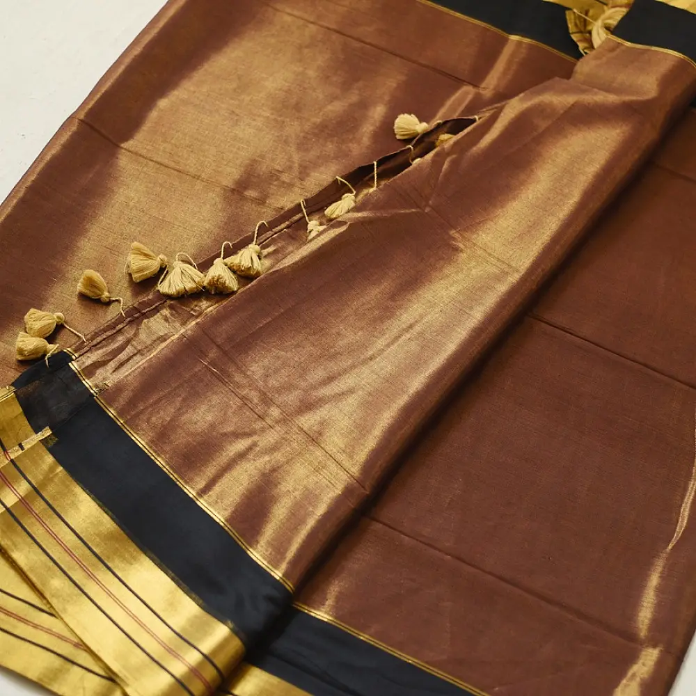 handloom pure cotton saree in deep rust orange with contrasting black border woven with metallic golden zari stripes and handcrafted tassels