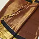 handloom pure cotton saree in deep rust orange with contrasting black border woven with metallic golden zari stripes and handcrafted tassels