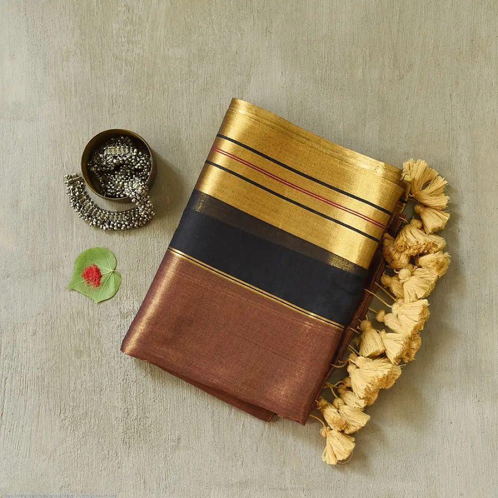 handloom pure cotton saree in deep rust orange with contrasting black border woven with metallic golden zari stripes and handcrafted tassels