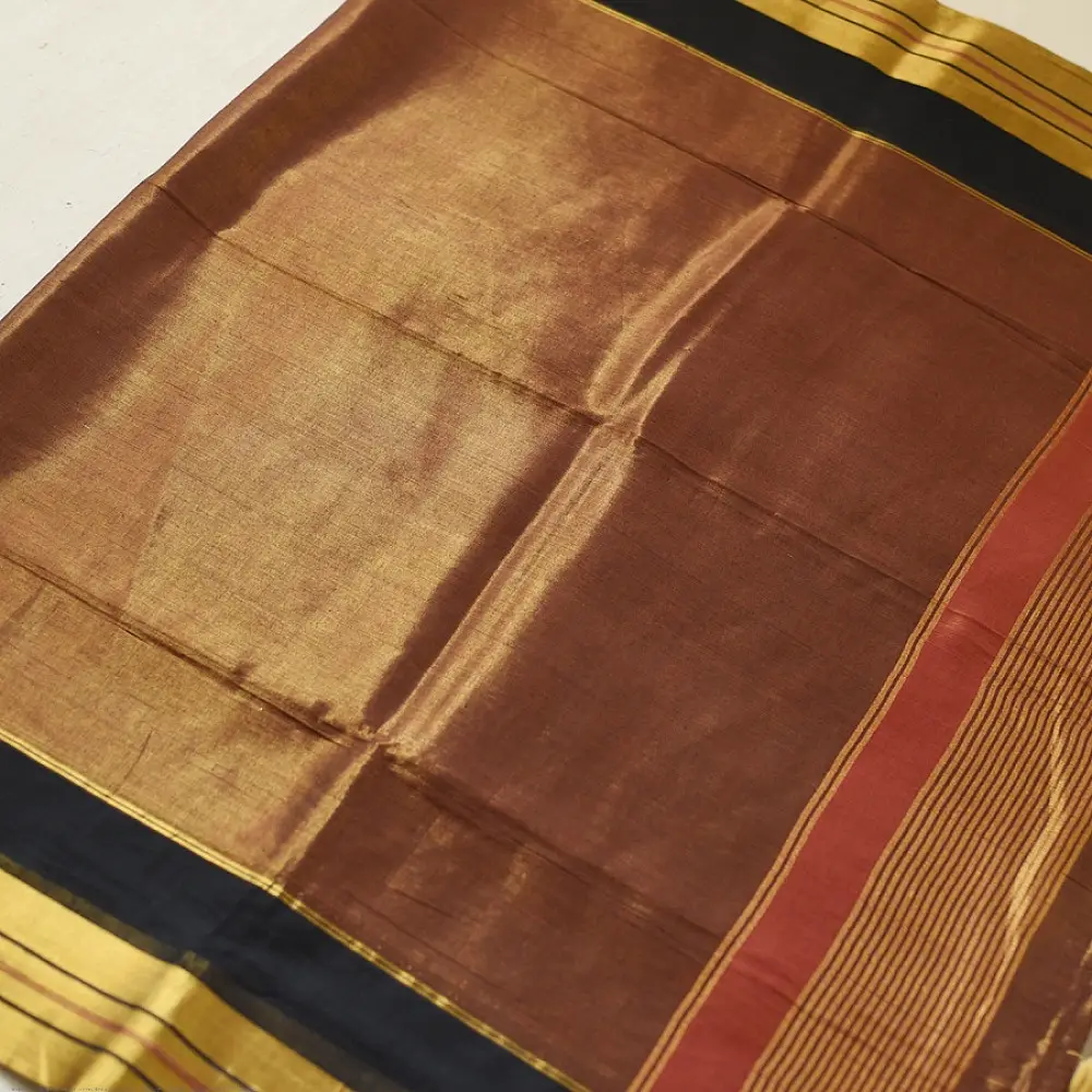 handloom pure cotton saree in deep rust orange with contrasting black border woven with metallic golden zari stripes and handcrafted tassels