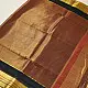 handloom pure cotton saree in deep rust orange with contrasting black border woven with metallic golden zari stripes and handcrafted tassels
