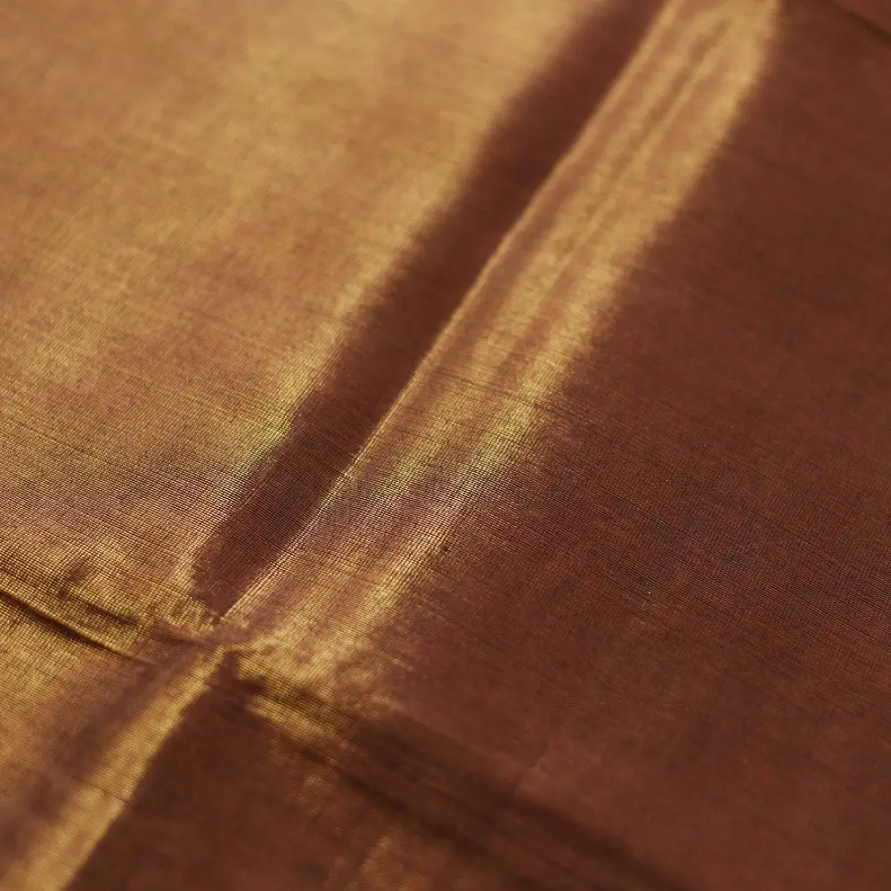 handloom pure cotton saree in deep rust orange with contrasting black border woven with metallic golden zari stripes and handcrafted tassels