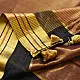 handloom pure cotton saree in deep rust orange with contrasting black border woven with metallic golden zari stripes and handcrafted tassels
