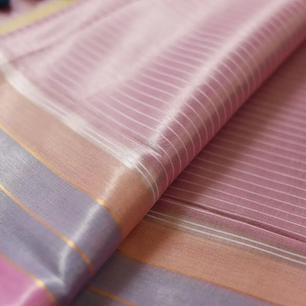handloom pure cotton saree in soft baby pink featuring subtle fine stripes contrast woven zari border and handcrafted turquoise blue tassels on pallu