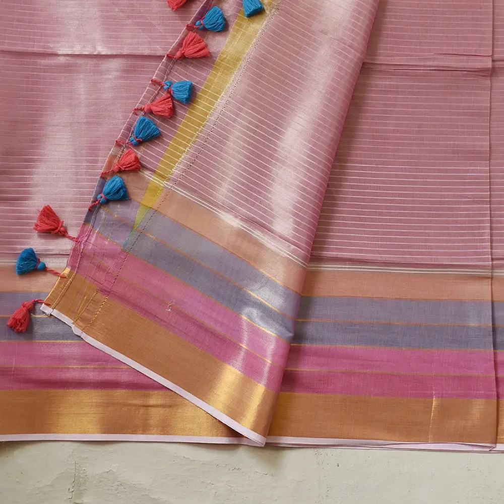 handloom pure cotton saree in soft baby pink featuring subtle fine stripes contrast woven zari border and handcrafted turquoise blue tassels on pallu