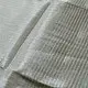 handloom pure cotton saree in soft grey and white featuring a bright lemon yellow color blocked panel with a black striped zari border and handcrafted tassels