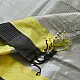 handloom pure cotton saree in soft grey and white featuring a bright lemon yellow color blocked panel with a black striped zari border and handcrafted tassels
