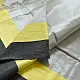 handloom pure cotton saree in soft grey and white featuring a bright lemon yellow color blocked panel with a black striped zari border and handcrafted tassels