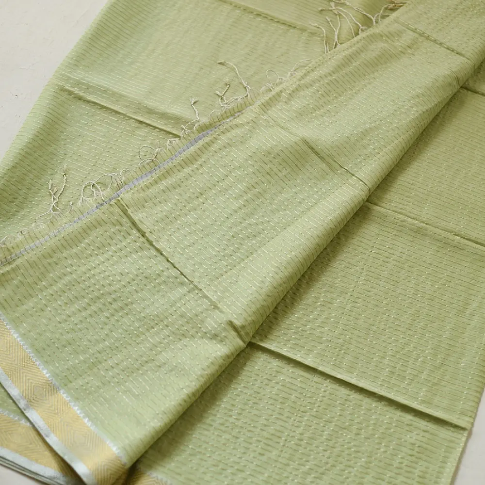 handloom pure cotton saree in subtle pista green featuring delicate fine stripes woven golden zari border and soft beige handcrafted tassels