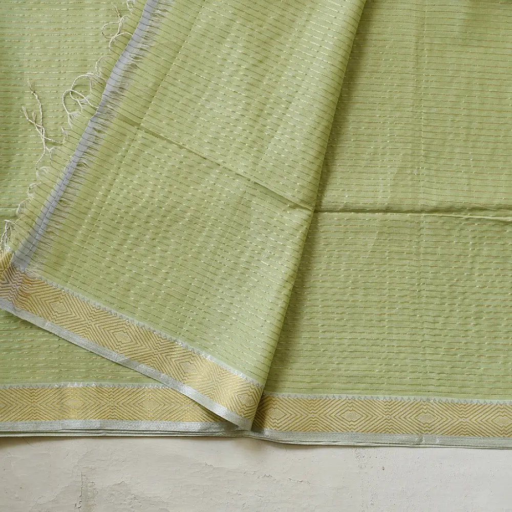 handloom pure cotton saree in subtle pista green featuring delicate fine stripes woven golden zari border and soft beige handcrafted tassels