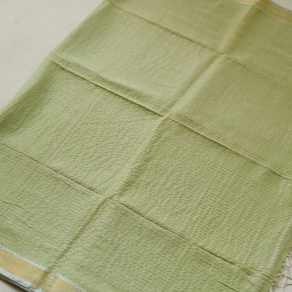 handloom pure cotton saree in subtle pista green featuring delicate fine stripes woven golden zari border and soft beige handcrafted tassels