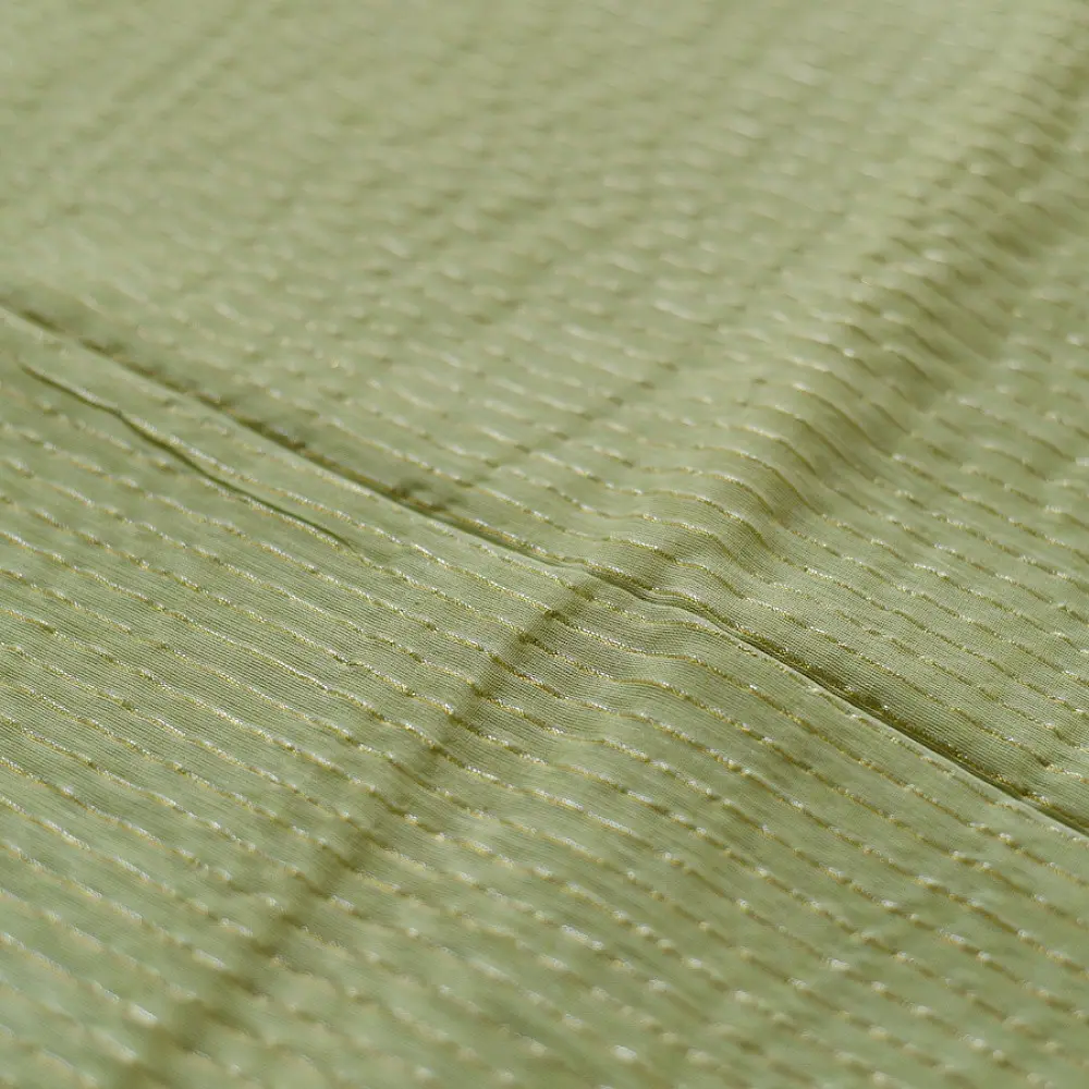 handloom pure cotton saree in subtle pista green featuring delicate fine stripes woven golden zari border and soft beige handcrafted tassels