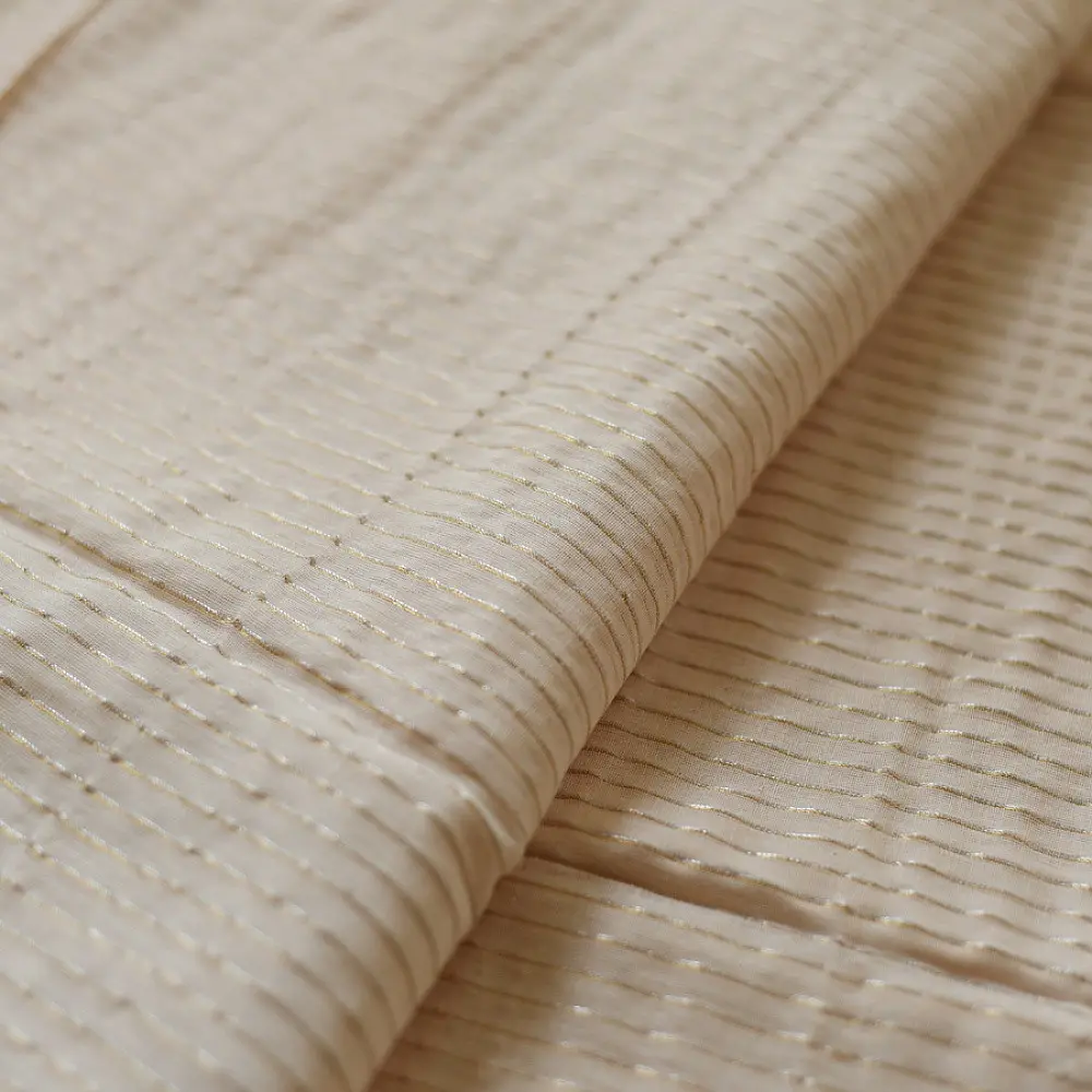 handloom pure cotton saree in luminous moti white featuring delicate micro stripes a woven gold zari border and soft handcrafted tassels