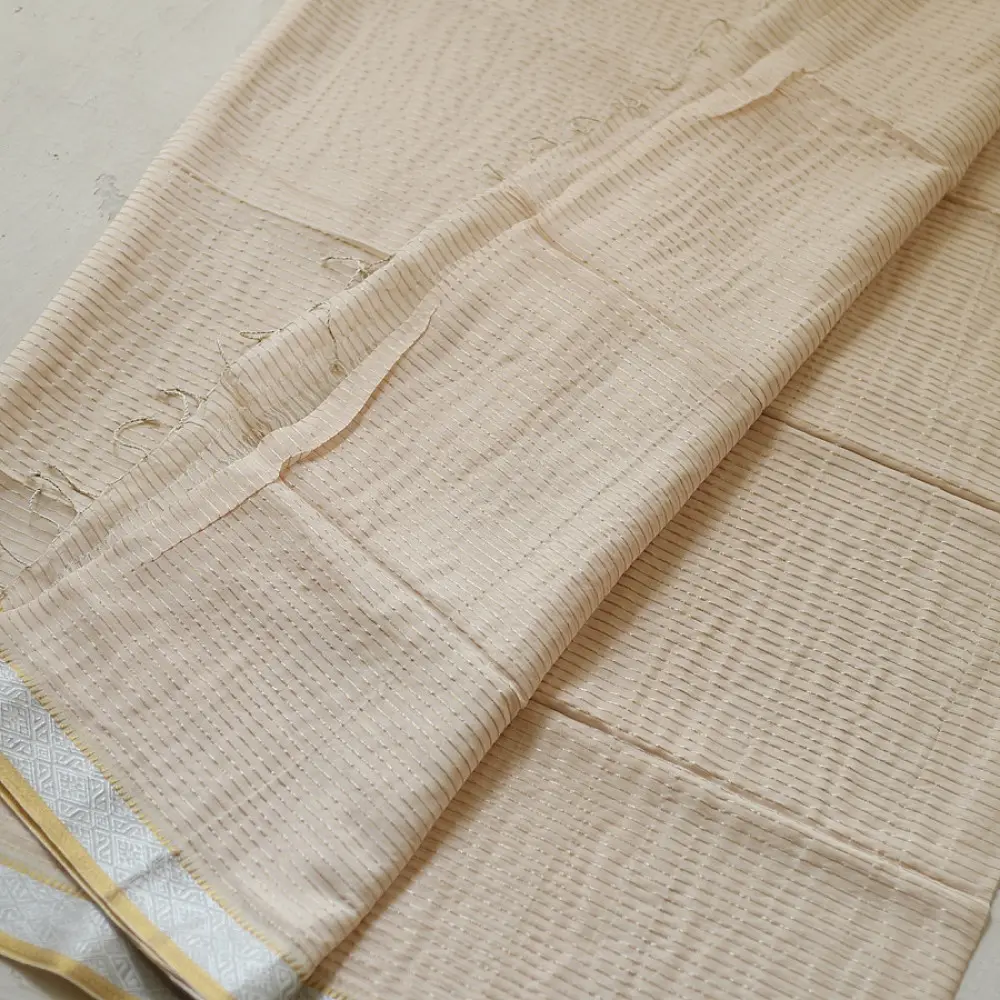 handloom pure cotton saree in luminous moti white featuring delicate micro stripes a woven gold zari border and soft handcrafted tassels