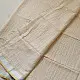 handloom pure cotton saree in luminous moti white featuring delicate micro stripes a woven gold zari border and soft handcrafted tassels
